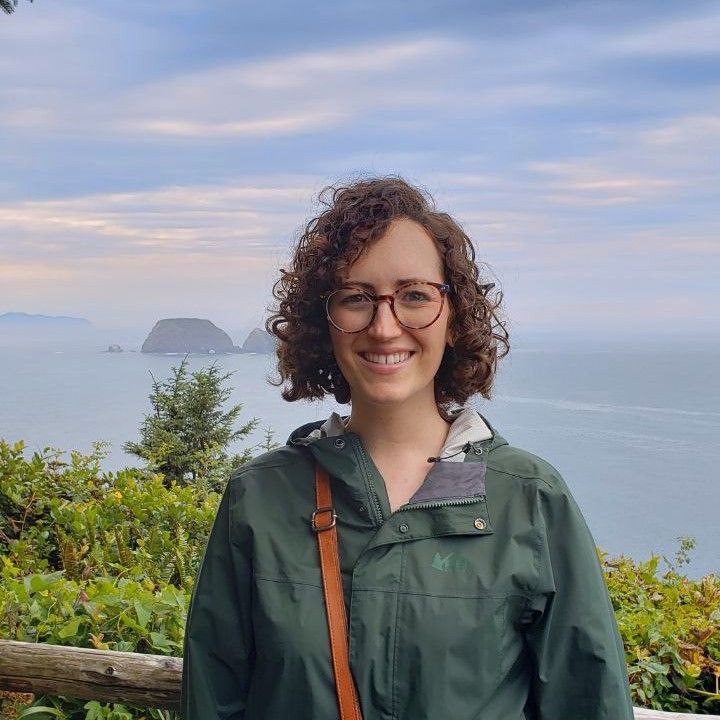 Kimberly standing in front of an overlook of the Pacific Ocean